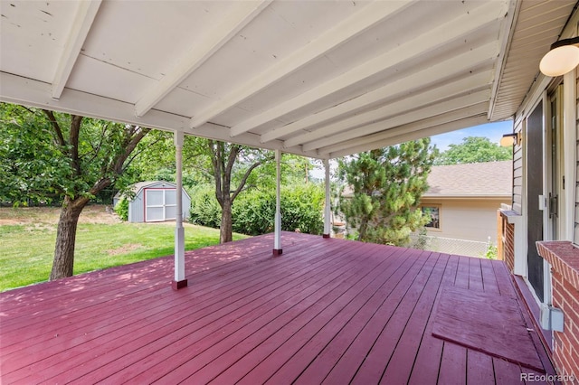 6749 S Foresthill St, Littleton, CO 80120 - wooden deck featuring a storage shed and a yard