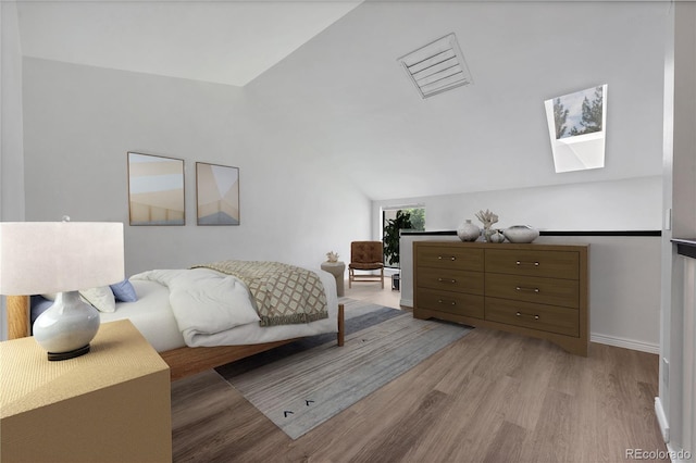 225 E 8th Ave Unit A2, Longmont, CO 80504 - bedroom with lofted ceiling, wood finished floors, and a skylight