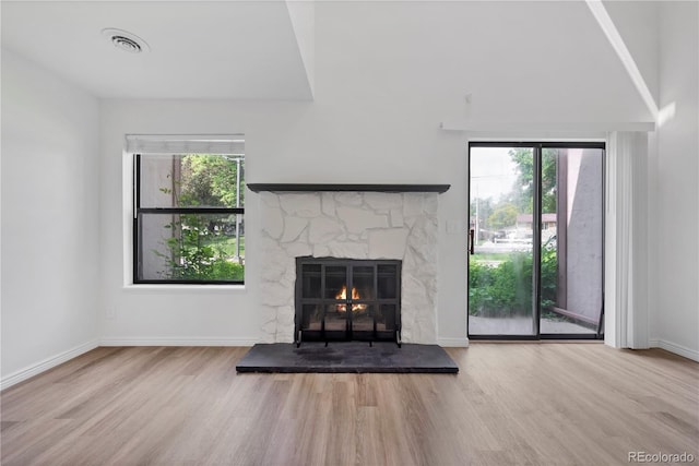 225 E 8th Ave Unit A2, Longmont, CO 80504 - unfurnished living room with wood finished floors, a fireplace, and baseboards