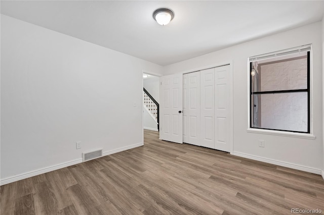 225 E 8th Ave Unit A2, Longmont, CO 80504 - unfurnished bedroom with wood finished floors, baseboards, and a closet