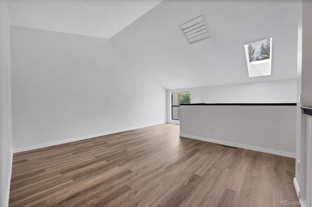225 E 8th Ave Unit A2, Longmont, CO 80504 - empty room with lofted ceiling, wood finished floors, a skylight, and baseboards
