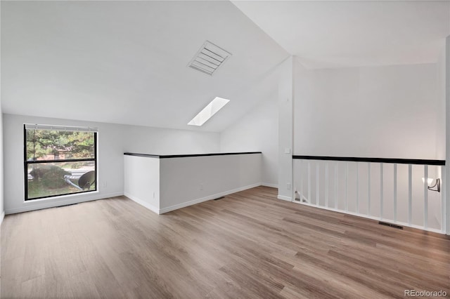225 E 8th Ave Unit A2, Longmont, CO 80504 - bonus room featuring a skylight, vaulted ceiling, wood finished floors, and baseboards