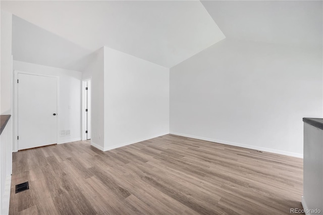 225 E 8th Ave Unit A2, Longmont, CO 80504 - additional living space featuring vaulted ceiling, wood finished floors, and baseboards
