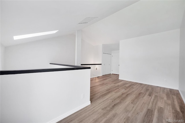 225 E 8th Ave Unit A2, Longmont, CO 80504 - spare room with a skylight, wood finished floors, vaulted ceiling, and baseboards