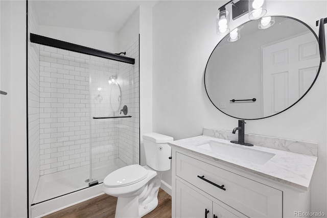 225 E 8th Ave Unit A2, Longmont, CO 80504 - full bath with wood finished floors, a stall shower, vanity, and toilet