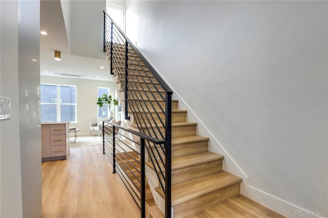 staircase featuring wood-type flooring