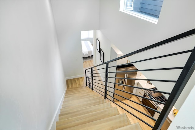 staircase with hardwood / wood-style floors