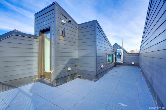 view of side of home featuring a patio area