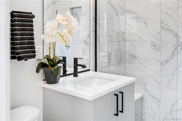 bathroom featuring vanity and toilet