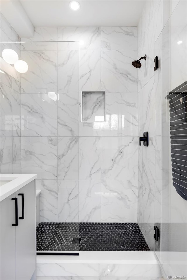 bathroom with vanity and a shower with shower door