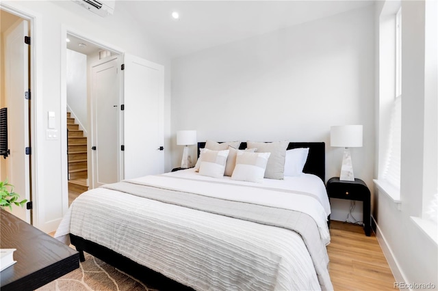 bedroom featuring light wood-type flooring and multiple windows