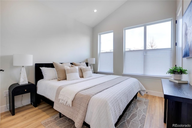 bedroom featuring light hardwood / wood-style floors and vaulted ceiling