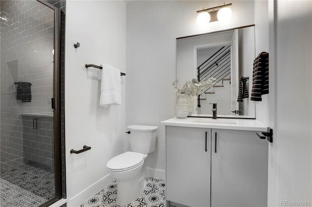 bathroom featuring walk in shower, tile patterned floors, vanity, and toilet