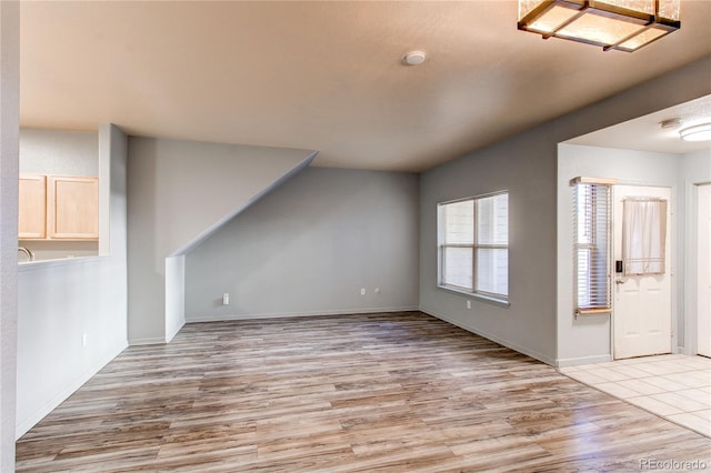 unfurnished living room featuring light wood-type flooring