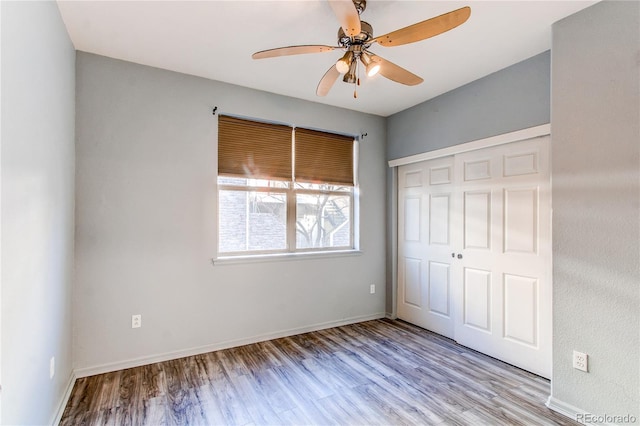 unfurnished bedroom featuring light wood-type flooring, a closet, and ceiling fan