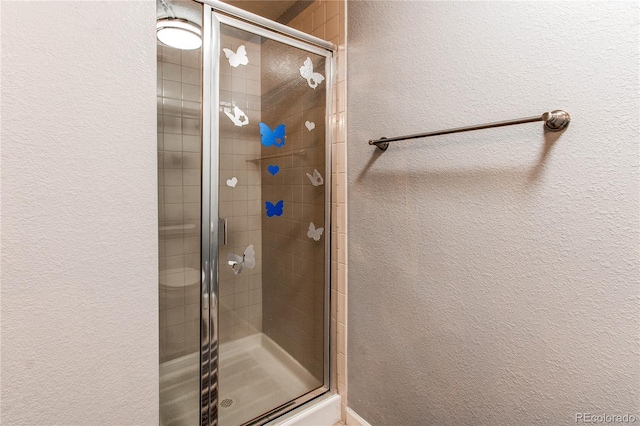 bathroom featuring a shower with door