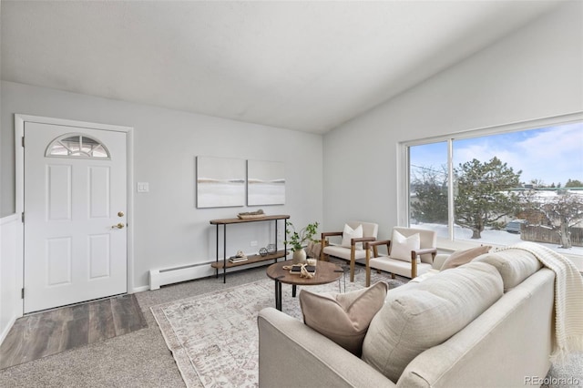 living room featuring baseboard heating and lofted ceiling