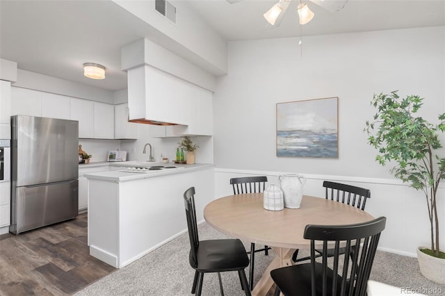 dining space with ceiling fan and dark hardwood / wood-style flooring