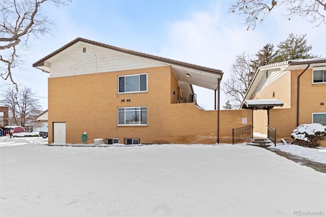 view of snow covered rear of property