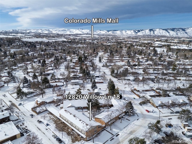 snowy aerial view with a mountain view