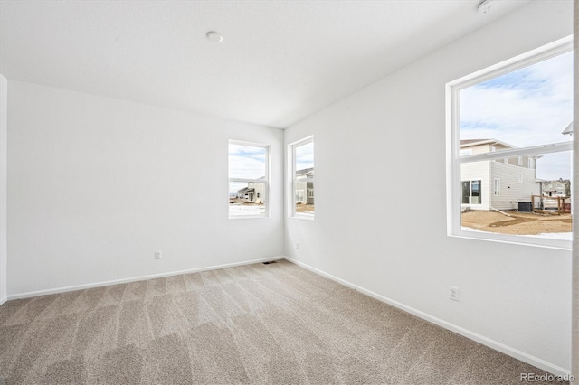 empty room featuring light carpet