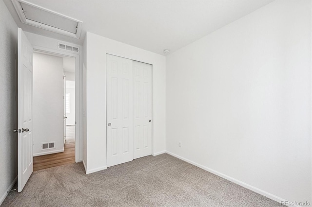 unfurnished bedroom with carpet and a closet