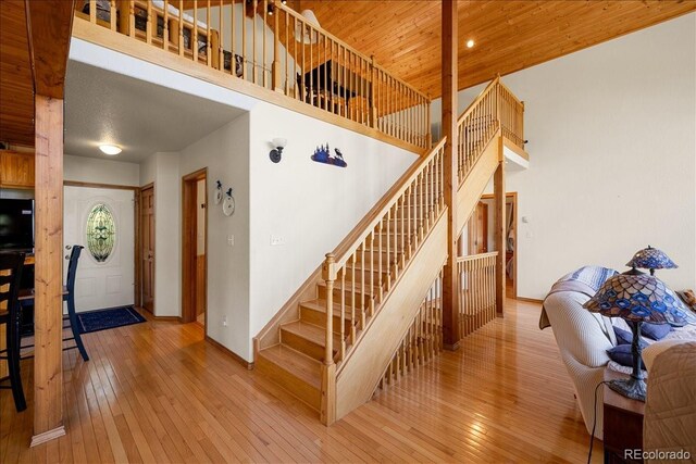 167 Wapiti Ct, Canon City, CO 81212 - stairway featuring hardwood / wood-style flooring, a towering ceiling, baseboards, and wood ceiling
