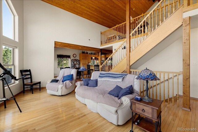167 Wapiti Ct, Canon City, CO 81212 - living room featuring a high ceiling, hardwood / wood-style flooring, stairs, and wood ceiling