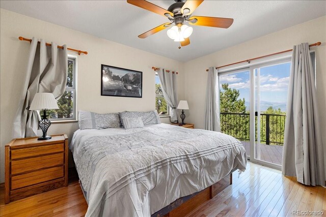 167 Wapiti Ct, Canon City, CO 81212 - bedroom featuring access to exterior, light wood-style flooring, multiple windows, and ceiling fan