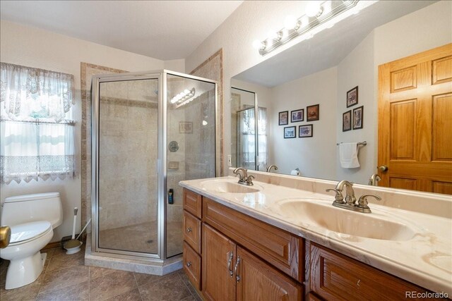 167 Wapiti Ct, Canon City, CO 81212 - bathroom featuring toilet, a stall shower, double vanity, and tile patterned floors