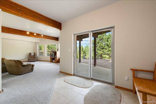 167 Wapiti Ct, Canon City, CO 81212 - entryway with beamed ceiling, baseboards, light tile patterned floors, and light colored carpet