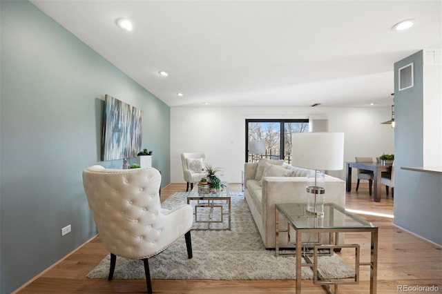 living area featuring recessed lighting, visible vents, and light wood-style flooring