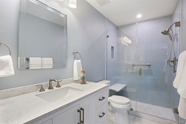 full bathroom with marble finish floor, visible vents, toilet, a stall shower, and vanity