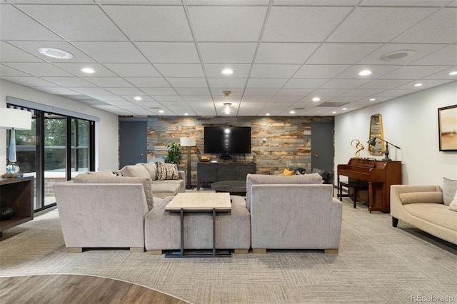 living area with wood finished floors, a paneled ceiling, and recessed lighting