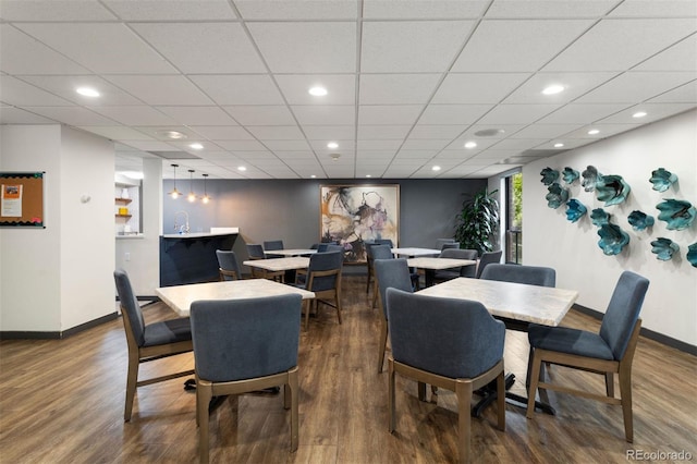 dining space with recessed lighting, baseboards, and wood finished floors