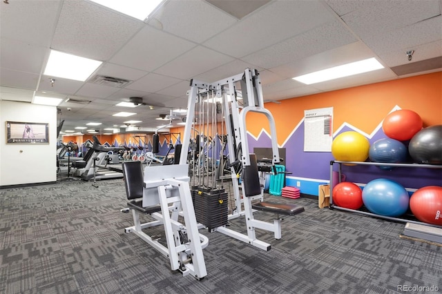 gym with baseboards, visible vents, and carpet flooring