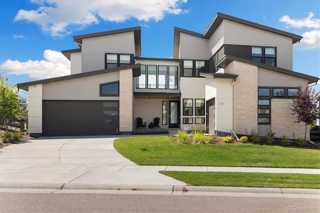 2221 Rim Ridge Dr, Castle Pines, CO 80108 - contemporary home with a balcony, concrete driveway, and a front lawn