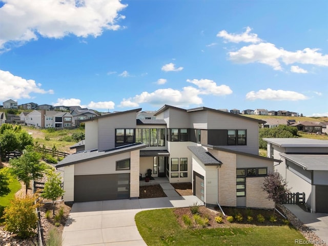 2221 Rim Ridge Dr, Castle Pines, CO 80108 - modern home with a garage, a residential view, and driveway
