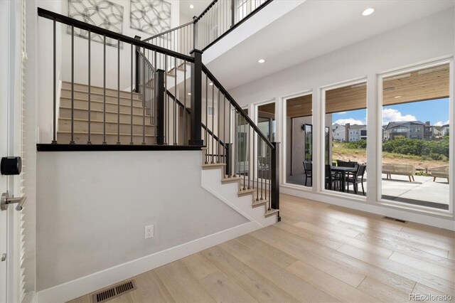 2221 Rim Ridge Dr, Castle Pines, CO 80108 - stairway featuring wood finished floors and recessed lighting
