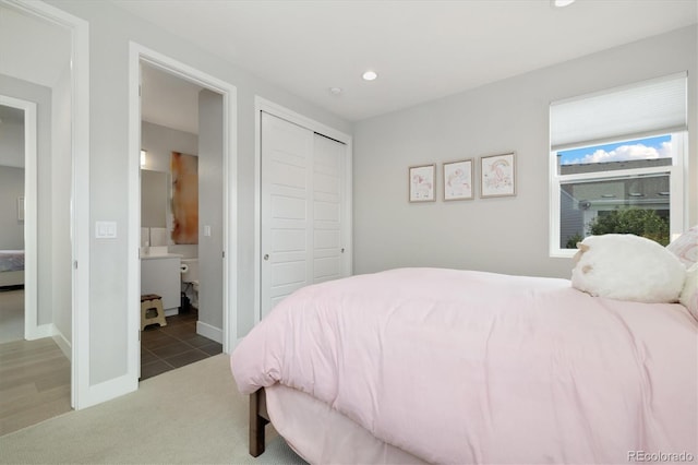 2221 Rim Ridge Dr, Castle Pines, CO 80108 - bedroom with light colored carpet, recessed lighting, a closet, and connected bathroom