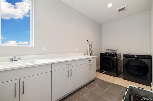 2221 Rim Ridge Dr, Castle Pines, CO 80108 - laundry room with washer and clothes dryer, cabinet space, dark tile patterned flooring, and recessed lighting