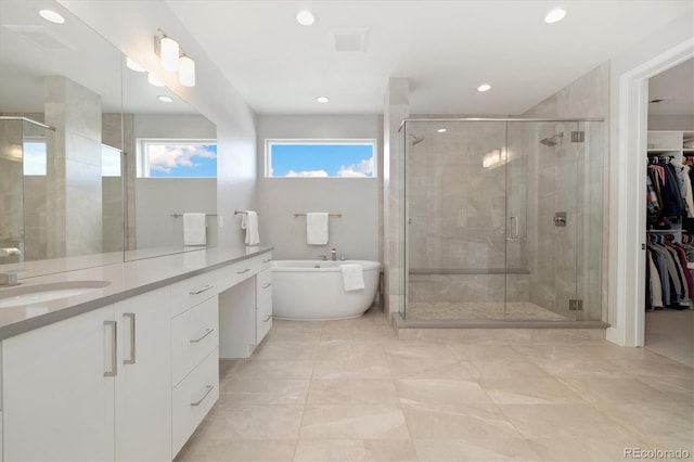 2221 Rim Ridge Dr, Castle Pines, CO 80108 - full bath with vanity, a freestanding tub, a stall shower, recessed lighting, and a walk in closet