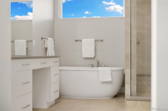 2221 Rim Ridge Dr, Castle Pines, CO 80108 - full bath with a freestanding bath, a shower stall, tile patterned flooring, and healthy amount of natural light