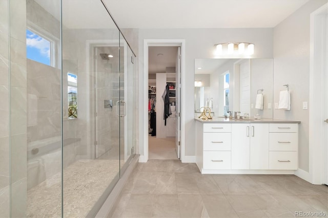 2221 Rim Ridge Dr, Castle Pines, CO 80108 - bathroom featuring a stall shower, vanity, a walk in closet, and marble finish flooring