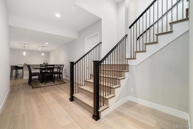 2221 Rim Ridge Dr, Castle Pines, CO 80108 - stairway featuring wood finished floors and recessed lighting