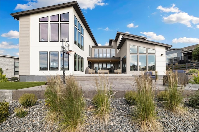2221 Rim Ridge Dr, Castle Pines, CO 80108 - rear view of house with stucco siding