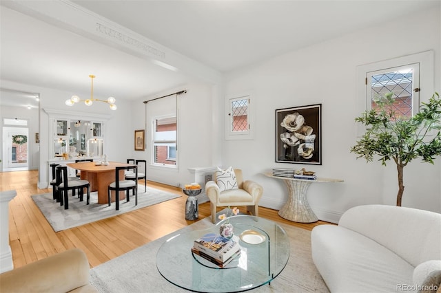 living room with baseboards and light wood-style floors