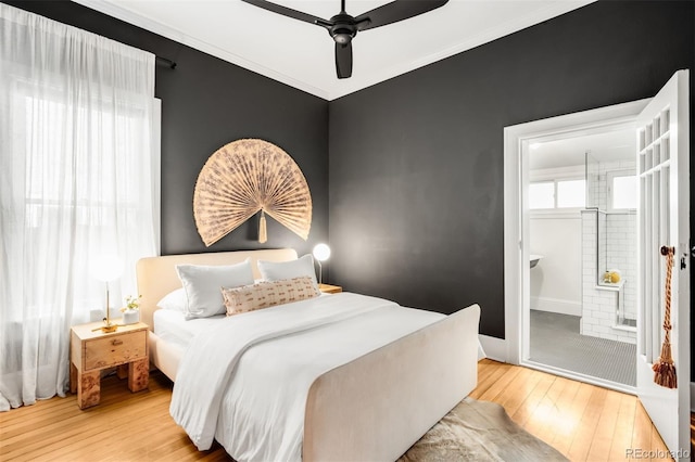 bedroom featuring baseboards, ornamental molding, ceiling fan, and wood-type flooring