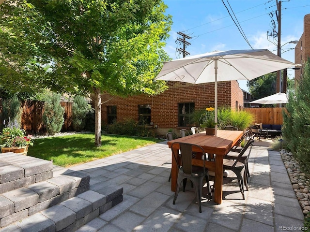 view of patio featuring fence and outdoor dining space
