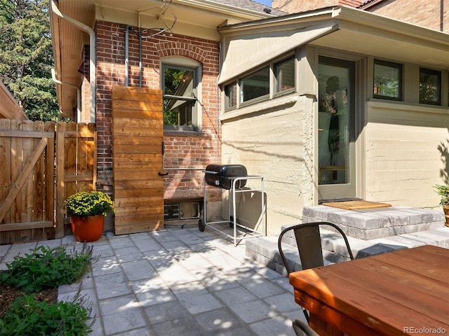 view of patio / terrace featuring grilling area and fence